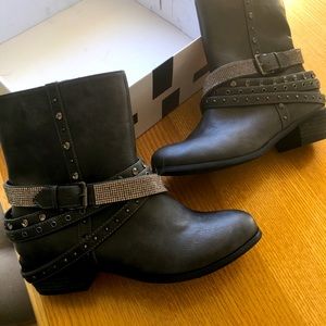 Gray leather boots with studded straps